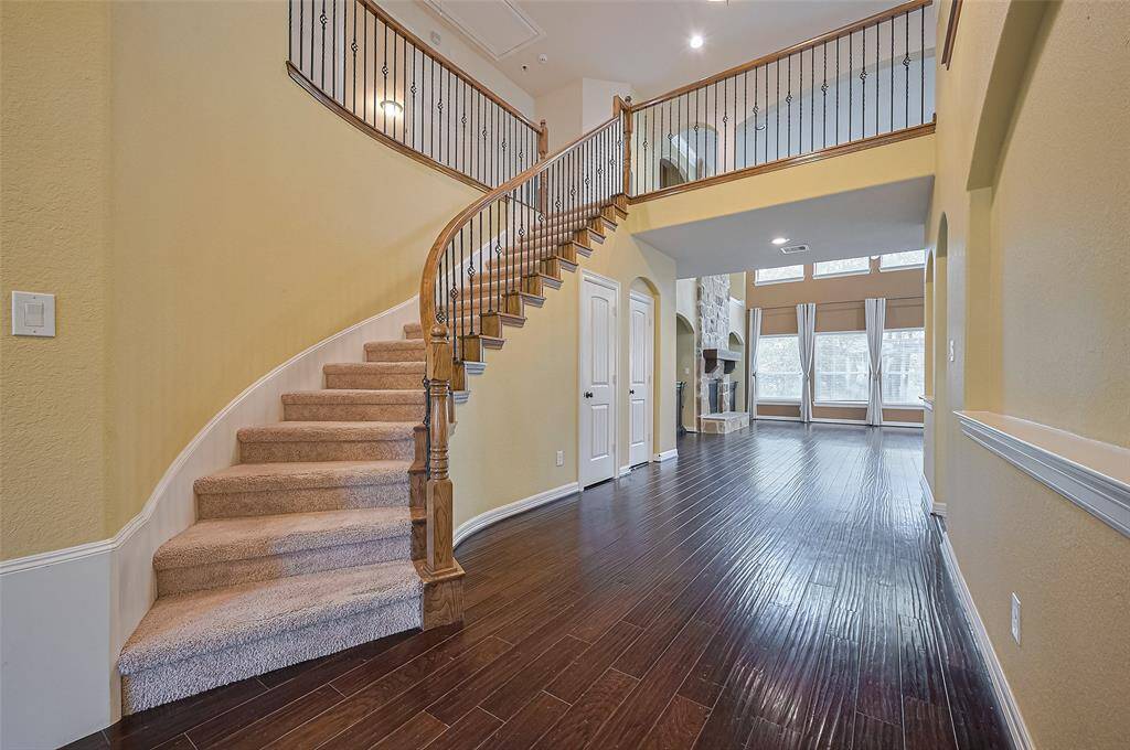 Beautiful staircase with a view straight through the living room from the front door.
