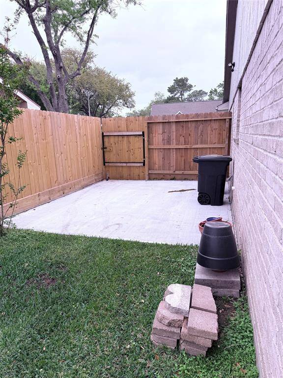 side of house with door to garage and concrete area