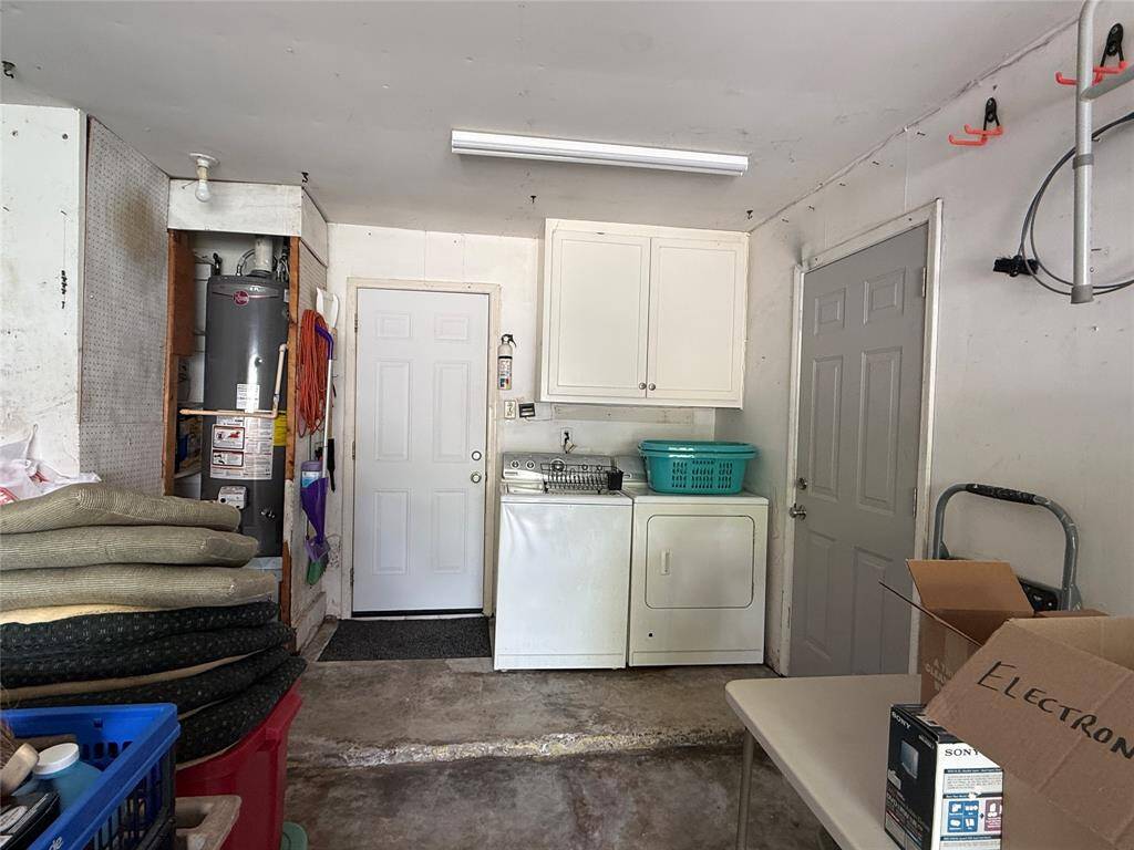 Garage with water heater, washer and dryer location and side door to back yard.