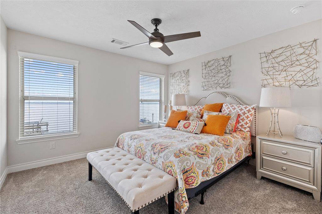 Wake up each morning to the tranquil beauty of the lake, with serene views right from the window of this cozy secondary bedroom.