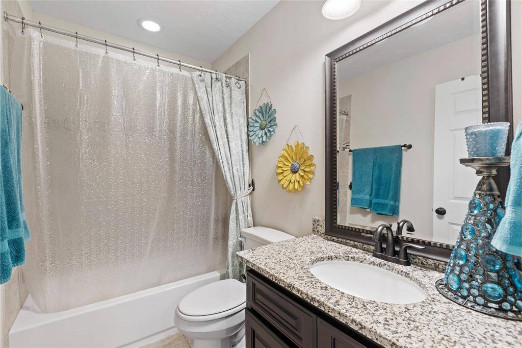 This second-floor bathroom offers a stylish and functional design, providing convenience for family or guests.