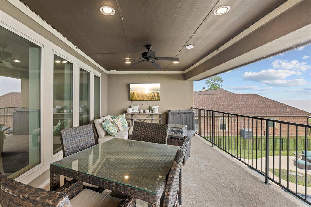 The covered balcony is designed for comfort, featuring ceiling fans to keep you cool and built-in speakers for the perfect entertainment experience. Sit back, relax, and enjoy the game on the mounted TV (not included) with serene lake views as your backdrop."