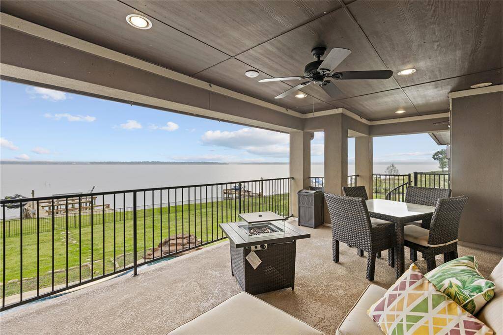 Enjoy unobstructed lake views from the covered balcony, complete with ceiling fans and a Bug Be Gone system for a cool, mosquito-free escape from the Texas heat