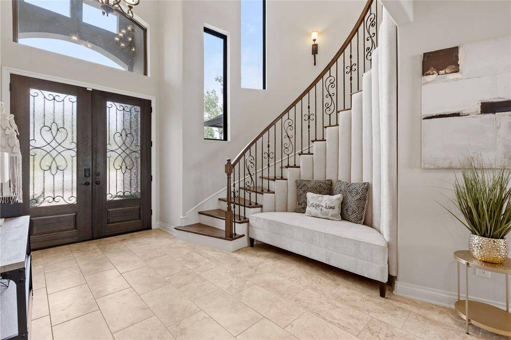 The plush, custom-built bench offers a cozy welcome, while the graceful architectural details hint at the luxury woven throughout the home.