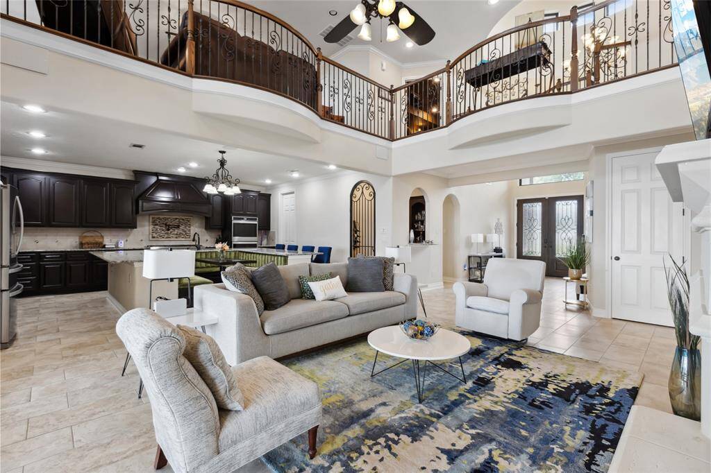 Step into the heart of this home, where open-concept living, high ceilings, and a seamless flow create the perfect space for entertaining. A beautiful wine room with a dry bar and wrought iron gate adds an elegant touch.