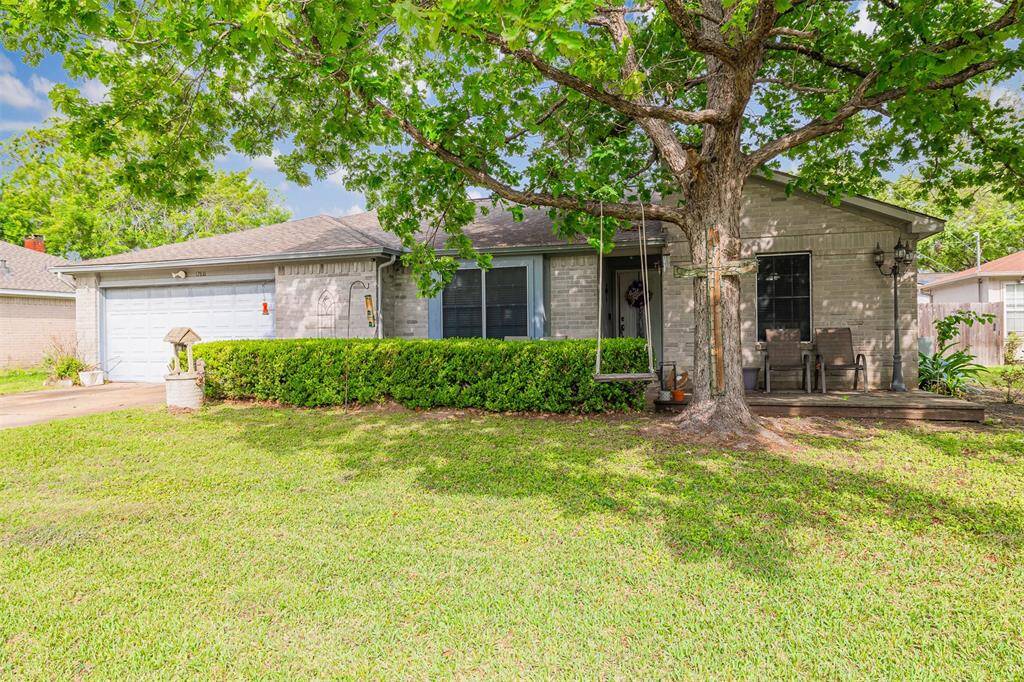 Beautiful one-story 4-bedroom 2-bath home with mature trees and front patio.