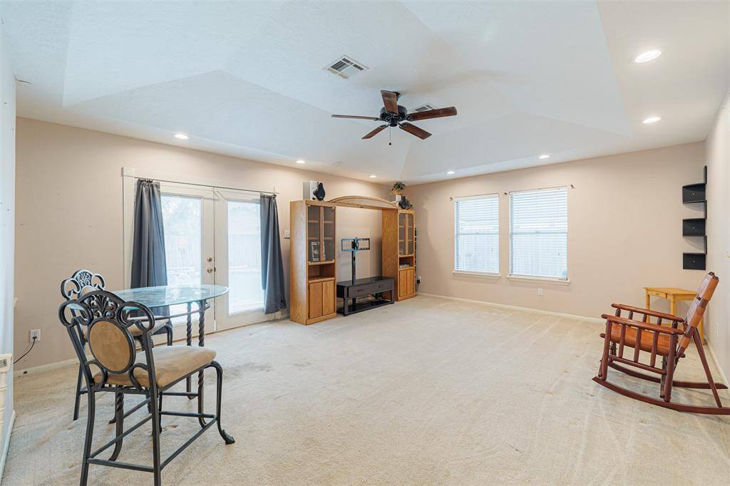 A large game room with vaulted ceilings and recessed lighting provides the perfect space for a pool table for family game nights or you can make it a movie room.