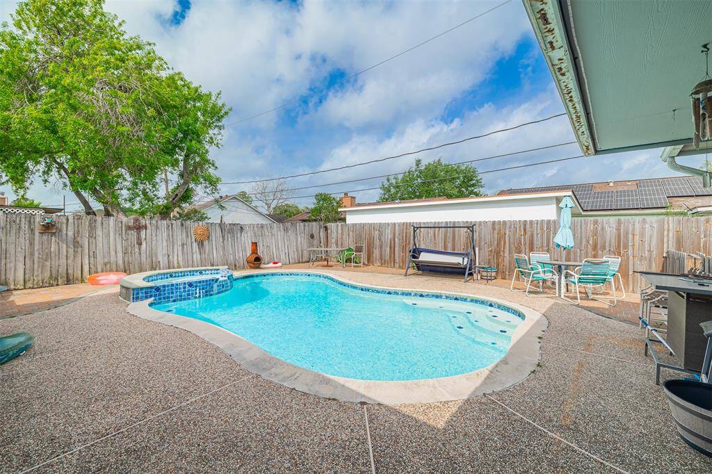 Step outside to a generous patio with a swimming pool and spa ideal for summer cookouts.