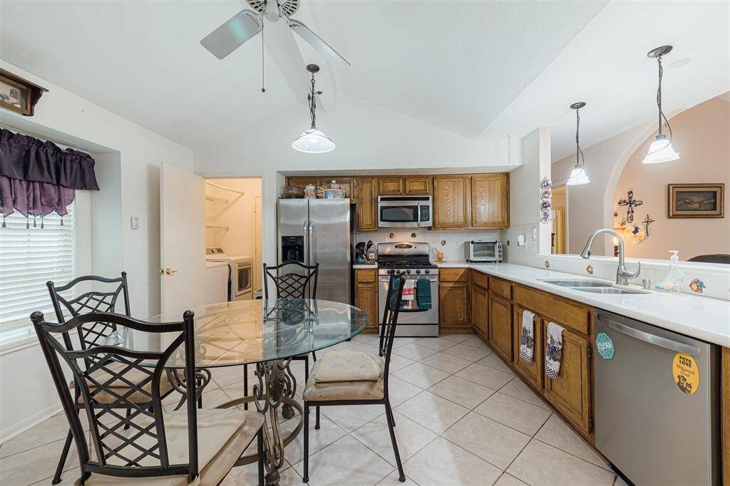 The kitchen also features granite counters, stainless steel appliances, tile flooring and high ceilings.