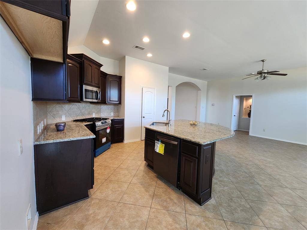 Another view of the kitchen and family room taken from the breakfast area