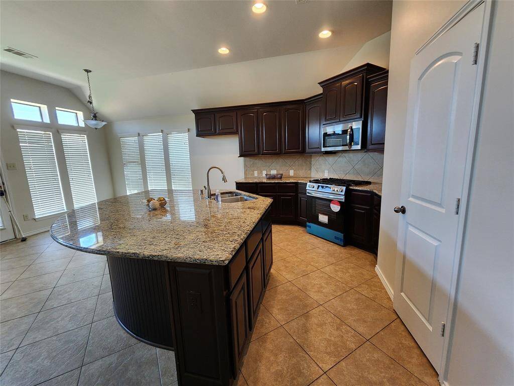 View of the kitchen and breakfast area.  The breakfast area adds a cozy touch and additional dining and entertainment space