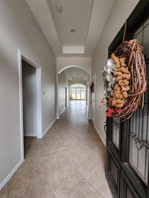 This is the elongated entry gallery filled with natural light, creating an inviting and airy ambiance as you step inside.