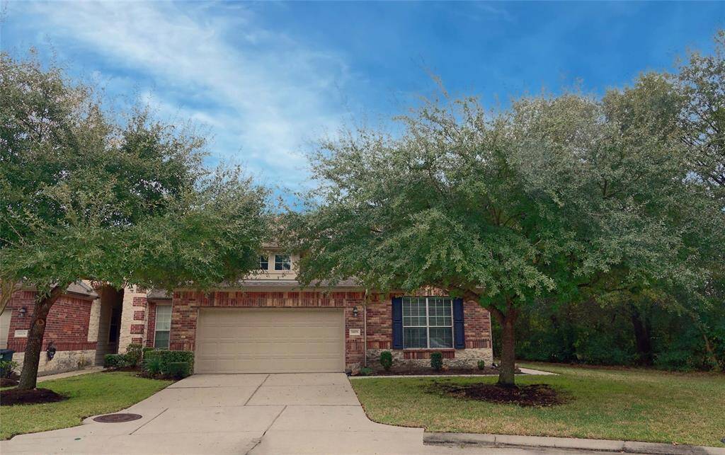 Front yard shaded by beautiful live oaks.