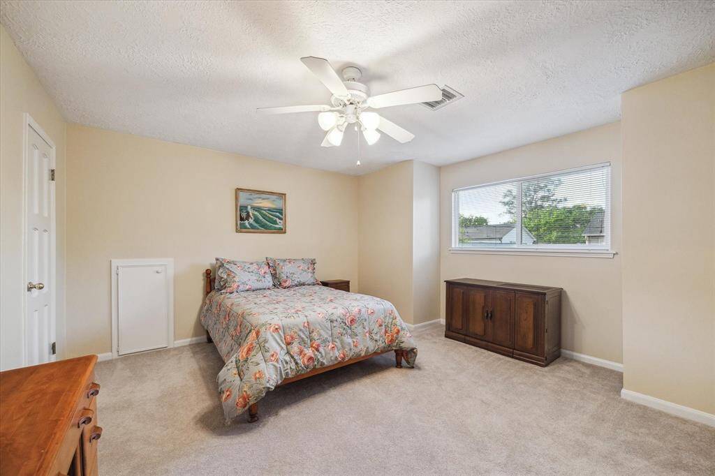 This delightful secondary bedroom located upstairs has light paint, fresh carpet and a large window overlooking the backyard. A large walk in closet is to the left. There is abundant closet space throughout this fine home.