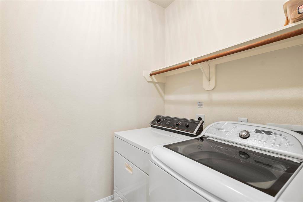 Laundry room with overhead shelving for your storage needs