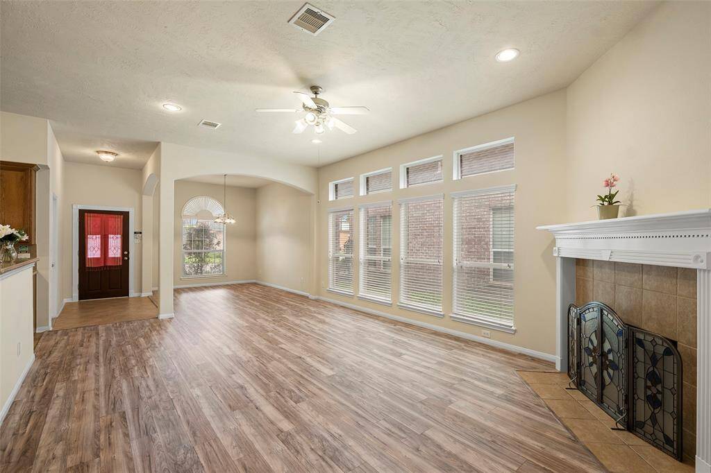 Big open family room with a cozy gas fireplace for family gatherings.