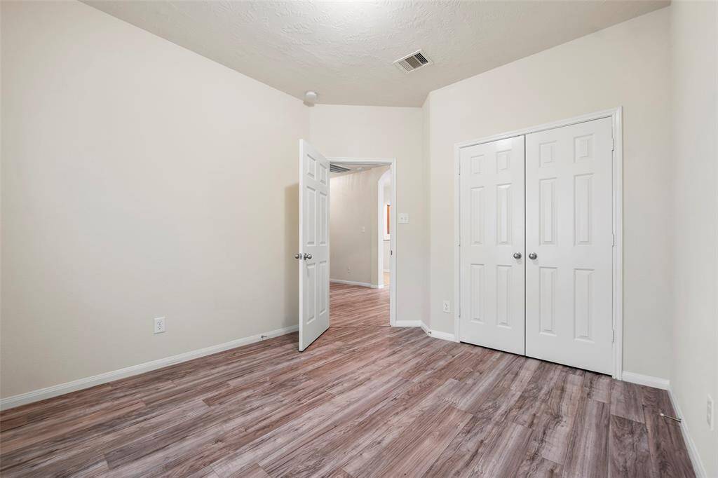 Secondary bedroom with double door closet.
