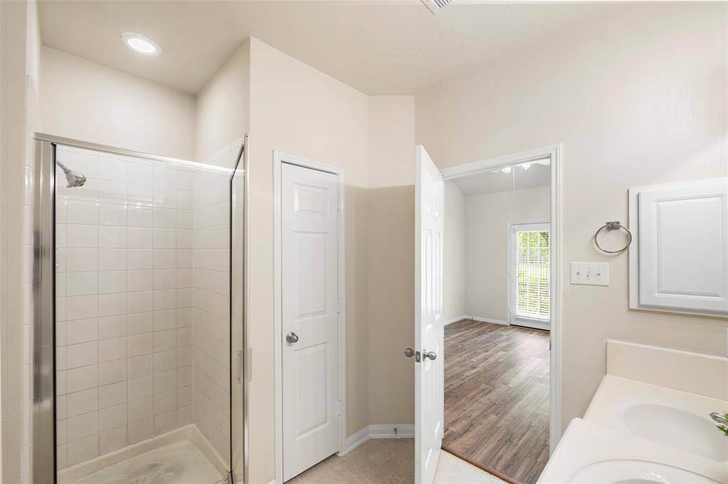 View of separate walk-in shower across from your whirlpool tub.