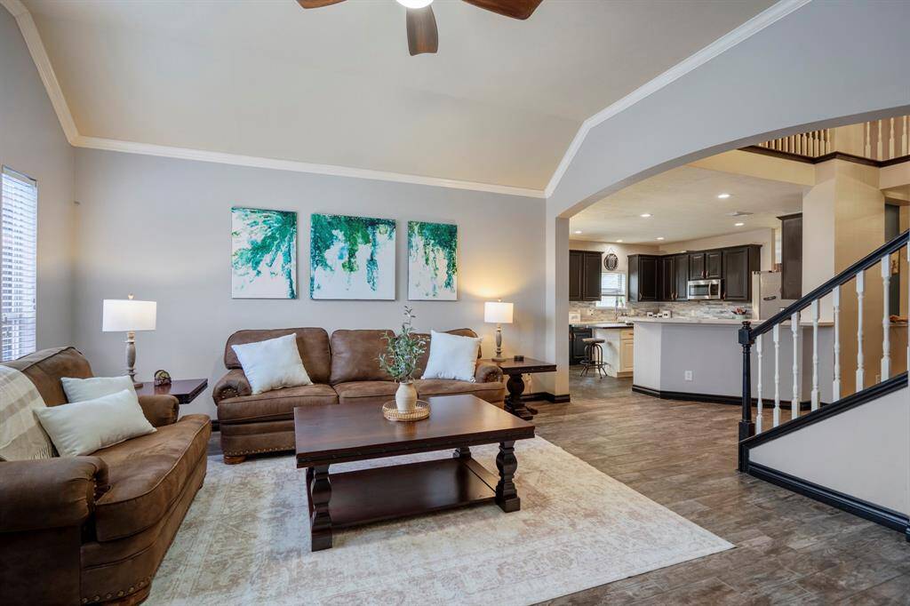 The family room is bright and welcoming, featuring abundant natural light, refreshed paint, wood-look tile flooring, and a stunning redesigned stacked-stone fireplace as the focal point. Whether you're cozied up for a movie night or simply gazing out at your backyard oasis, this space was made for relaxing