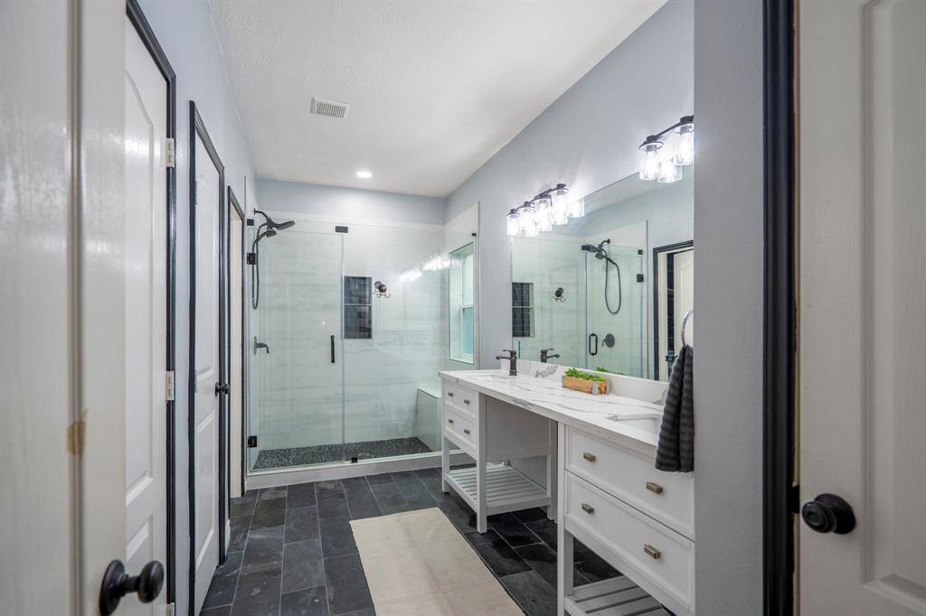 ou’ll love getting ready—or unwinding—in your remodeled, spa-like primary bathroom. Thoughtfully designed with dual sinks, quartz countertops, built-in storage, and a Texas-sized walk-in shower with a bench. You’ll also find a spacious walk-in closet with custom built-in cabinetry, a linen closet, and a secondary closet that’s ideal for a gun safe or extra storage.