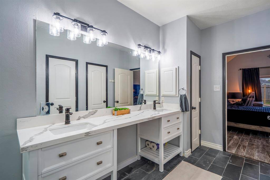 ou’ll love getting ready—or unwinding—in your remodeled, spa-like primary bathroom. Thoughtfully designed with dual sinks, quartz countertops, built-in storage, and a Texas-sized walk-in shower with a bench. You’ll also find a spacious walk-in closet with custom built-in cabinetry, a linen closet, and a secondary closet that’s ideal for a gun safe or extra storage.