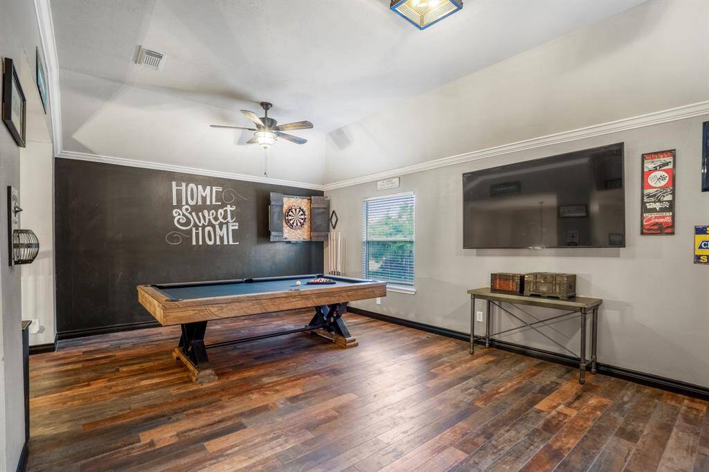 This expansive game room offers endless possibilities—whether it’s a friendly game of pool, a round of darts, or a relaxed movie night, there’s room for it all.