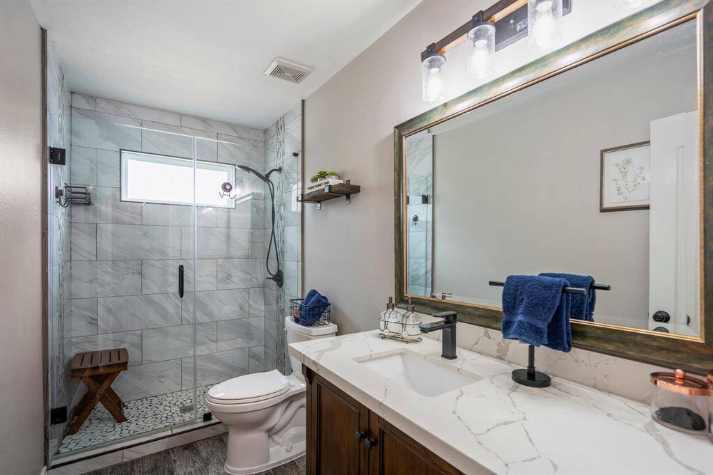 Enjoy your fully remodeled secondary bathroom, featuring sleek quartz countertops and a Texas-sized walk-in shower—blending everyday function with designer flair