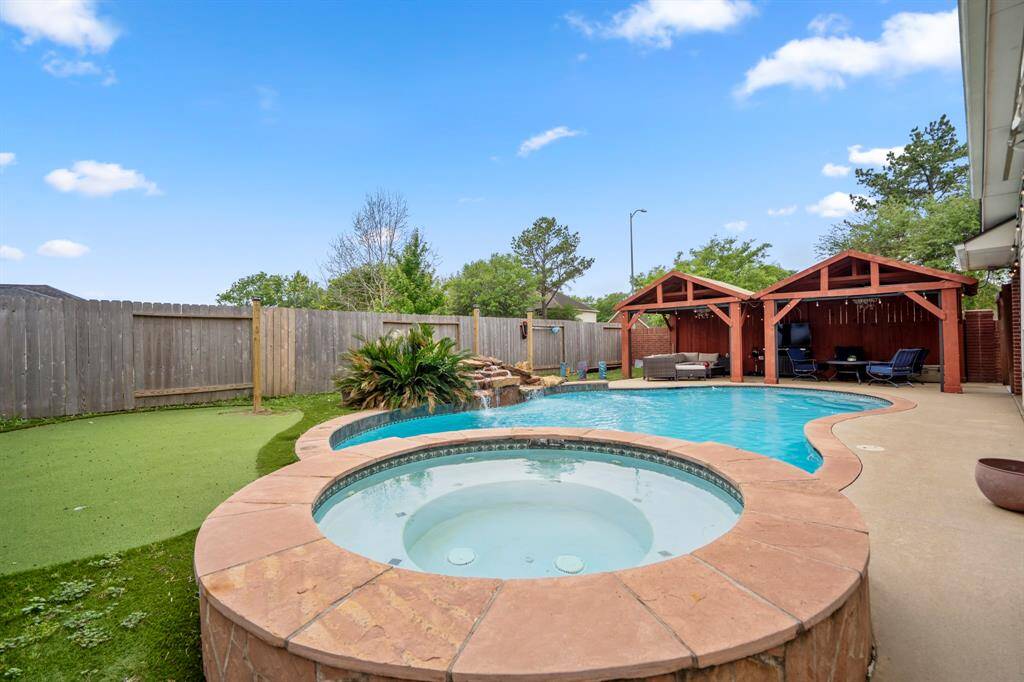 This is where the fun begins—your own private backyard oasis! Dive into the heated pool, relax in the hot tub, or unwind under the covered pergolas equipped with electricity. Practice your short game on the putting green, and enjoy the low-maintenance lifestyle with lush astro turf that keeps things looking pristine year-round.