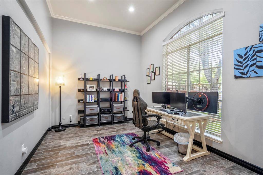 Just off the entry, a spacious office or flex space awaits—featuring soaring ceilings and an abundance of natural light. Whether you're working from home or need a creative retreat, this space delivers both function and style.