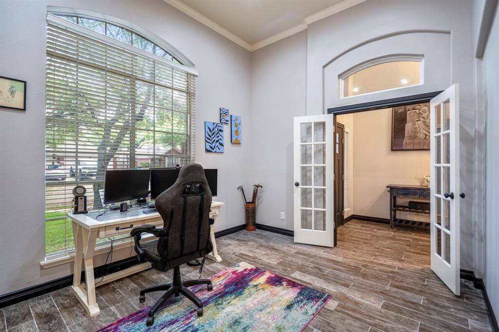 Just off the entry, a spacious office or flex space awaits—featuring soaring ceilings and an abundance of natural light. Whether you're working from home or need a creative retreat, this space delivers both function and style.