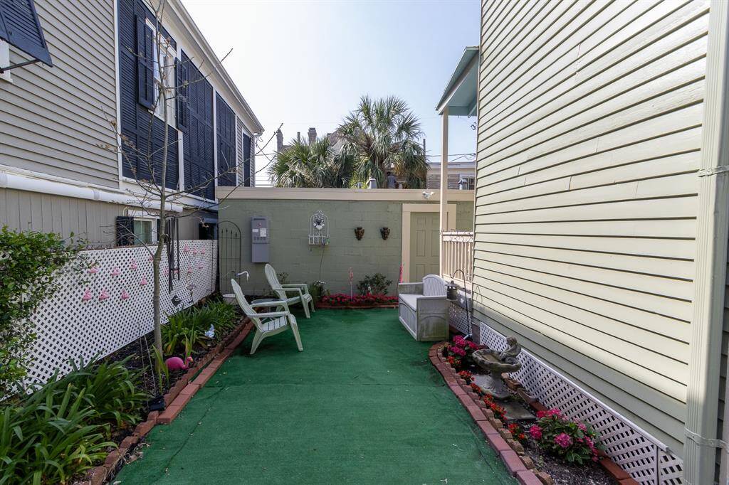 Side yard on east side of the property with the two car garage in the background.