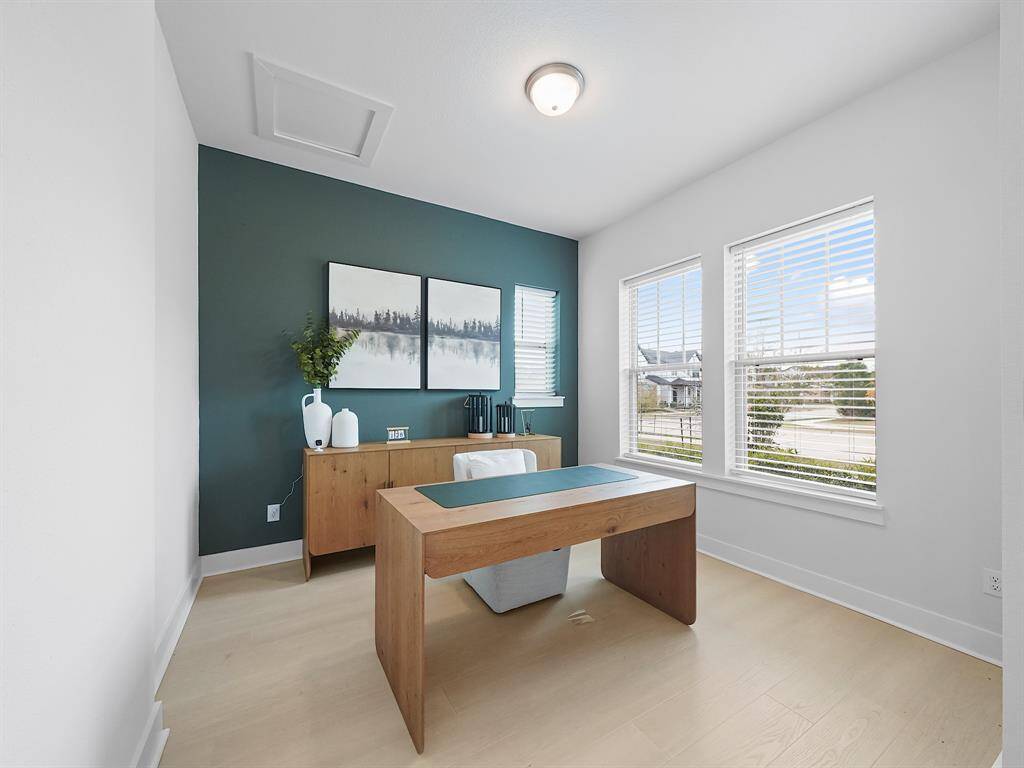 The home office is bright, spacious and filled with natural light and views of the front yard.