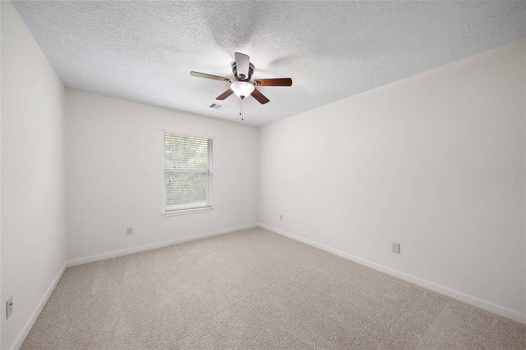 3rd bedroom with new carpet. All bedrooms have ceiling fans.