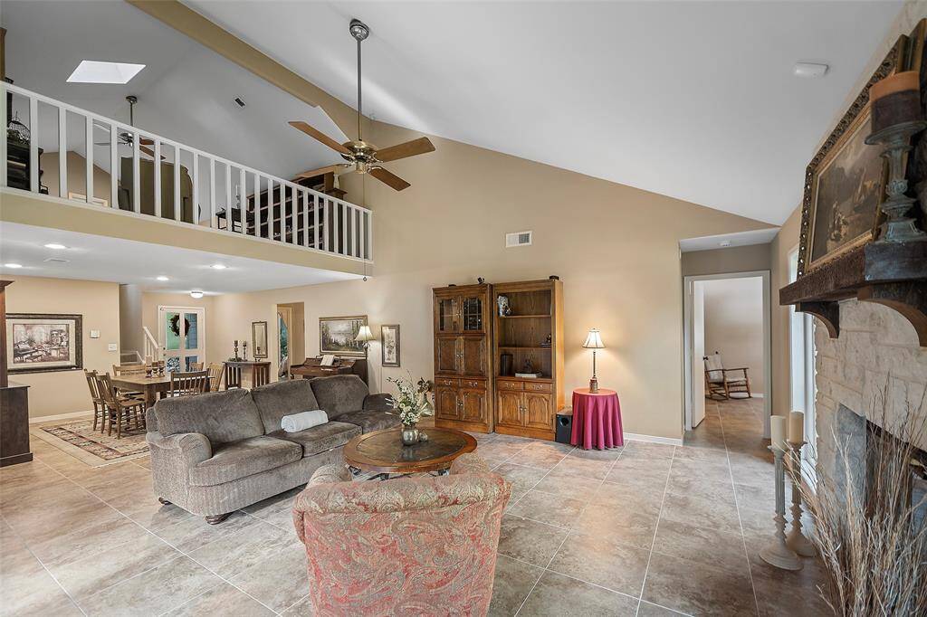 This spacious family room awaits you and yours to spend the evening together, talking about your day or helping with homework in the dining area!