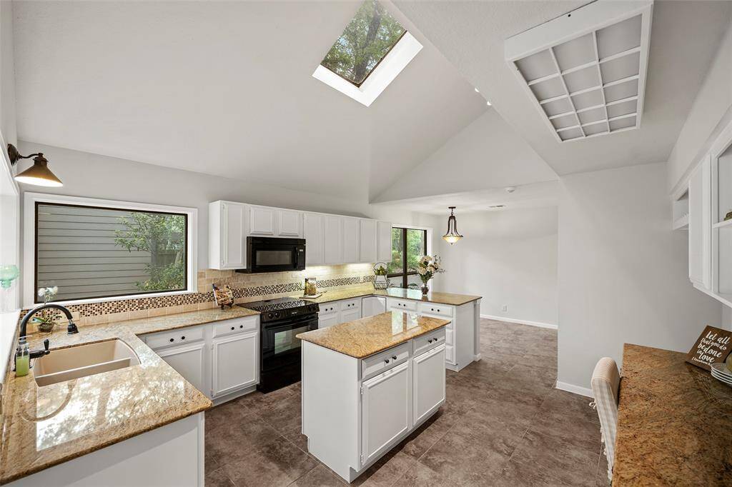 An exquisite island kitchen with warm oak cabinets provides ample storage space and granite countertops for meal preparations! A large picture window and skylight, offers plenty of natural light for any task at hand!