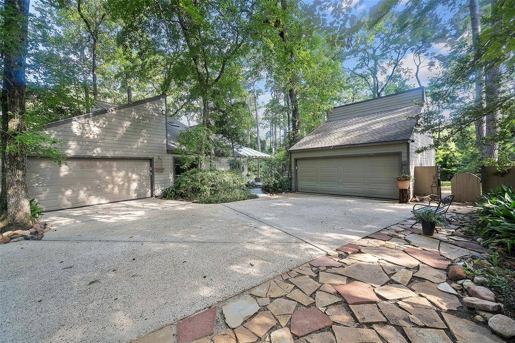 This home boasts a 2-car garage and an auto-court area with pavestone pathways surrounding by more beautiful foliage!