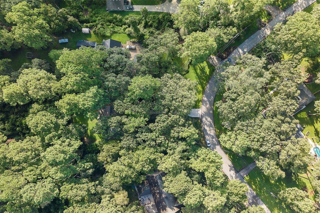 A bird's eye view shows you how much natural beauty surrounds this 1-acre property! There is also room for a garden, chicken coup or maybe a pool, if you so desire! Horses and cattle are allowed too!