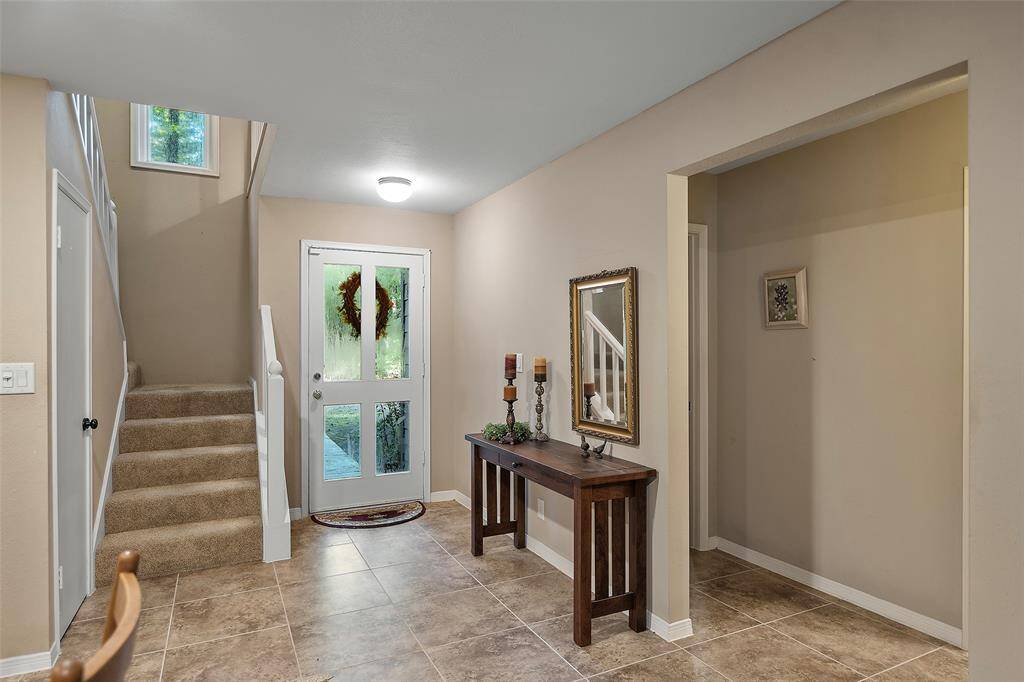 As you enter, you will notice this light and bright entryway! The front door has beautiful glass, and the staircase has a window perched above, allowing all that natural light to flow into the space!