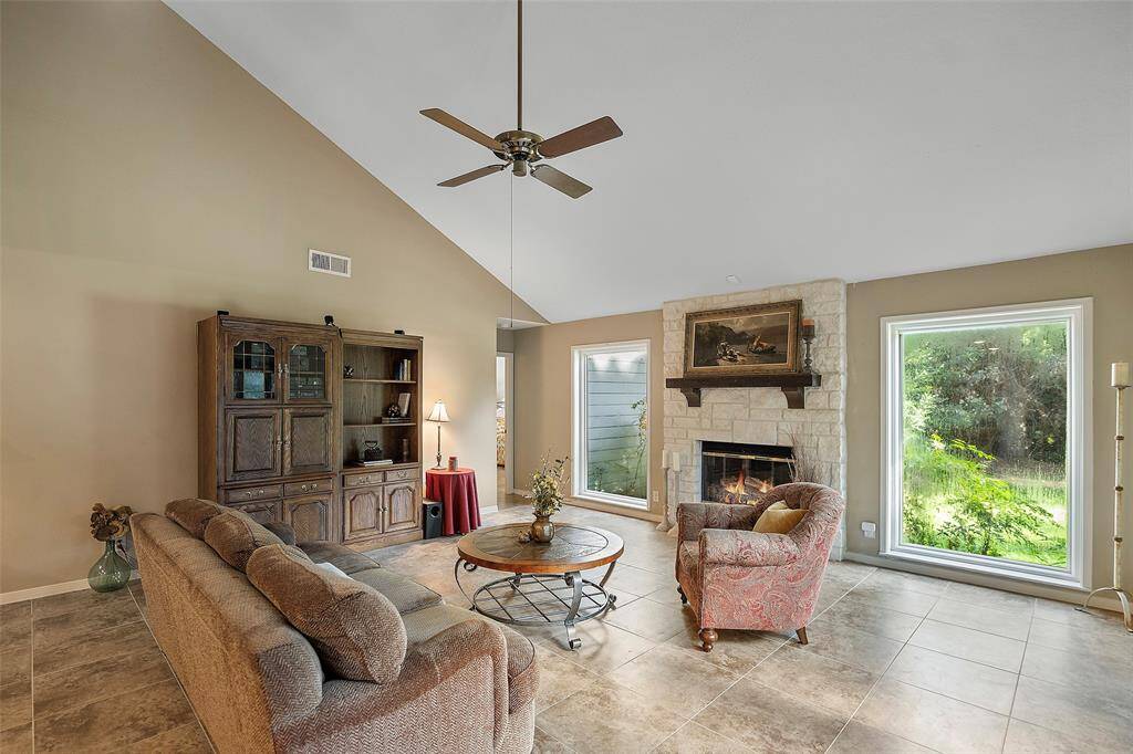 A floor to ceiling stone fireplace with custom wood mantel will surely warm the hearts of all that gather here!