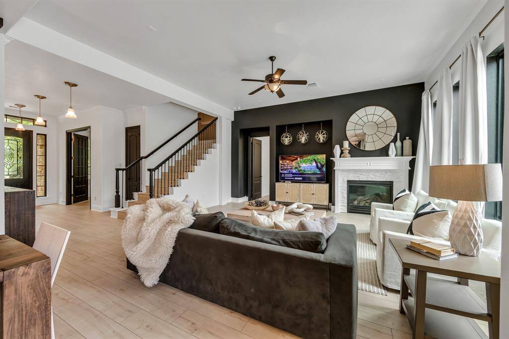The living room with striking black walls are complemented by a beautiful tiled fireplace exuding warmth and comfort.