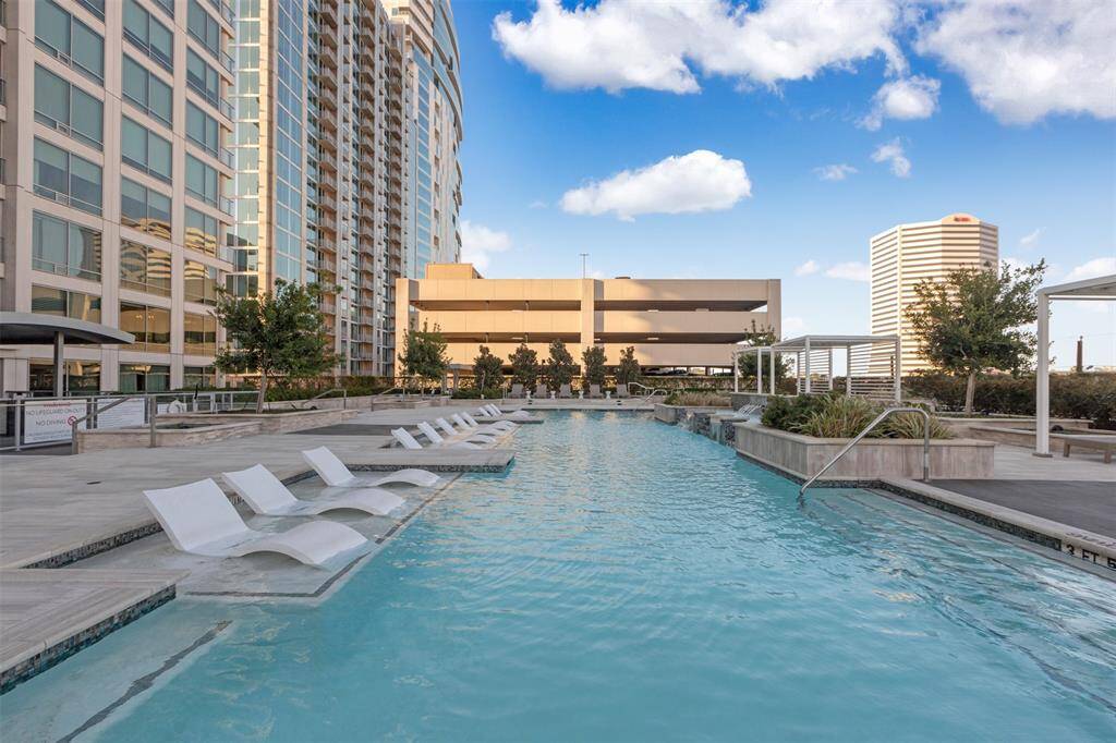 Lounge poolside in style—this 4th-floor resort-style pool features in-water loungers, lush landscaping, and skyline views, creating the perfect urban escape right outside your door.