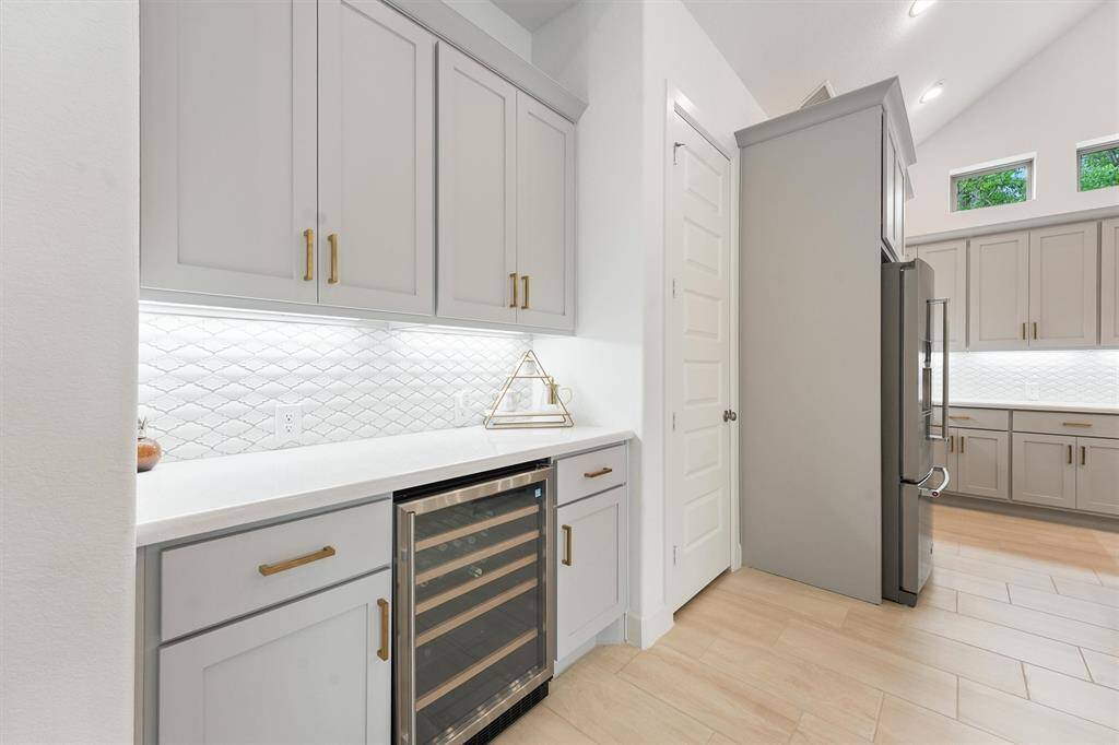 High ceilings, polished beams and recessed lighting create an elegant living and dining experience
