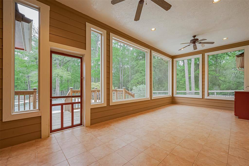 This sunroom offers beautiful views out the picture windows overlooking the pool/spa.