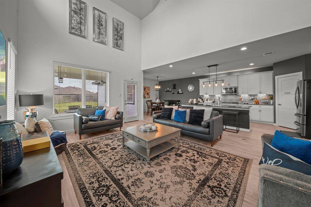 Bright, open, and beautifully styled—this living space flows effortlessly into the kitchen and dining area for easy, elegant living.