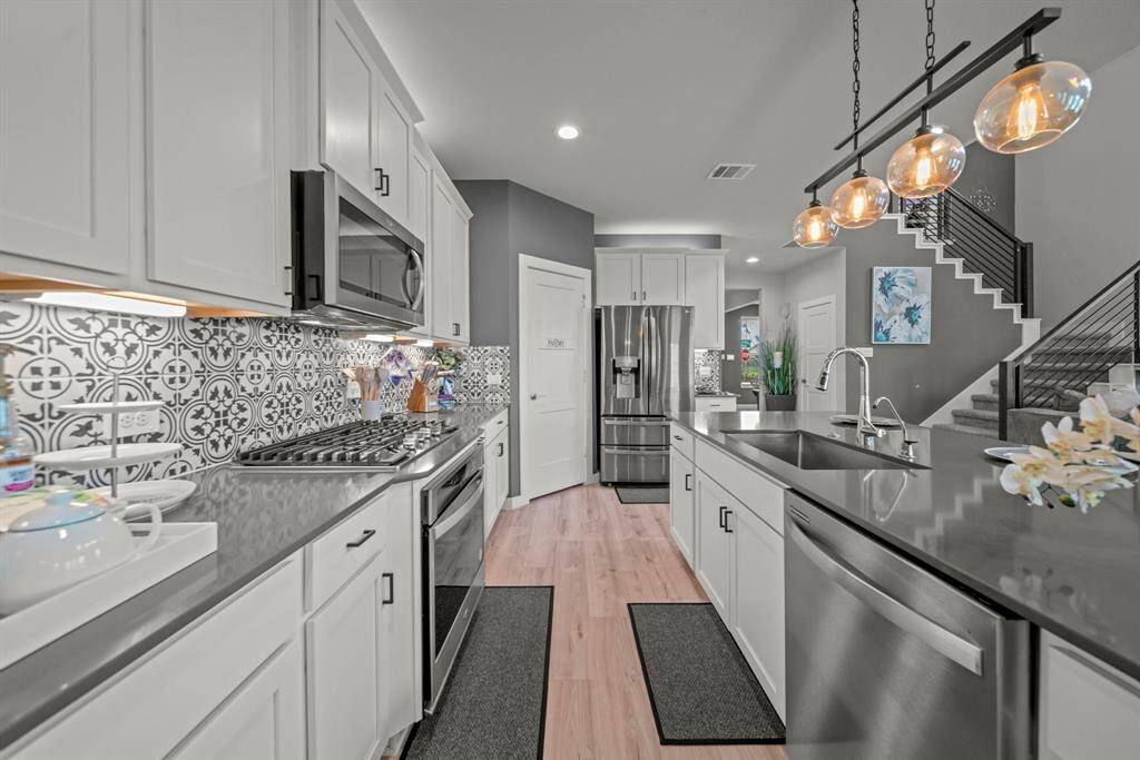 Whip up something fabulous in the kitchen with bold backsplash flair, sleek finishes, and lighting that totally sets the mood!