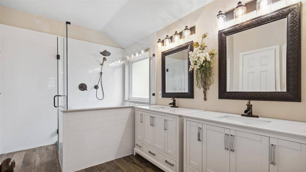 The spa-like primary ensuite features dual sink vanities, an oversized shower, and a spacious walk-in closet.