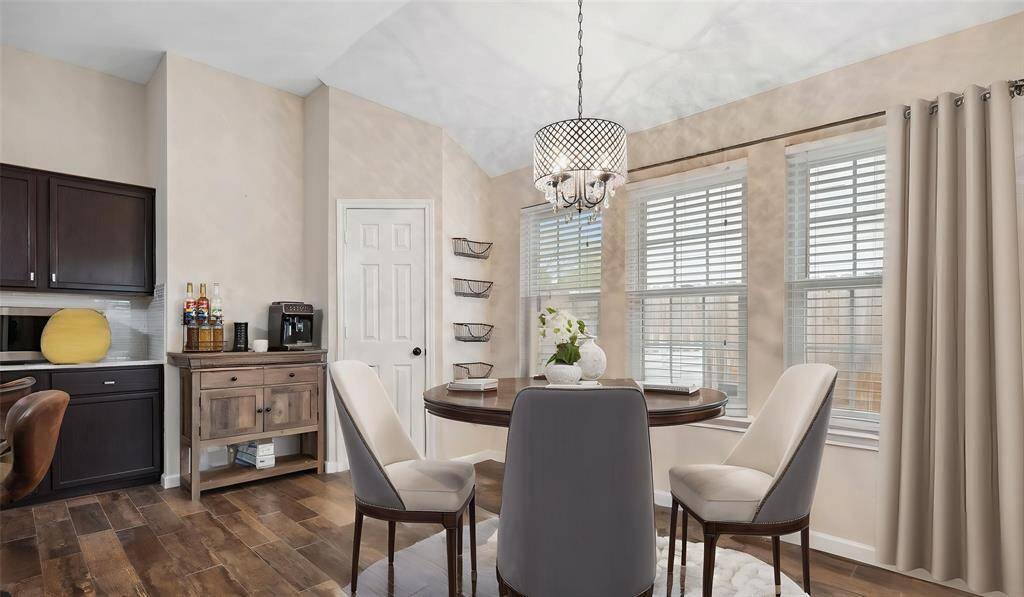 The generously sized breakfast room, located just off the kitchen, offers plenty of space for casual dining and everyday gatherings. A stunning wall of windows fills the room with natural light.