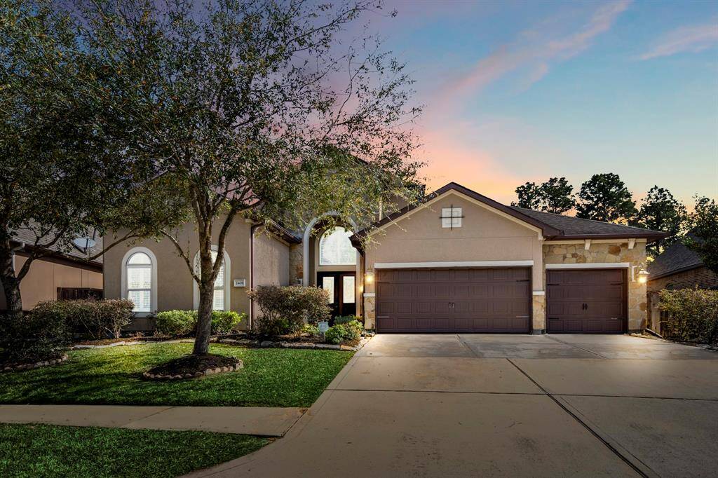 Luxury Dunn & Stone home in the gated Lakes of Cypress Forest, Spring, TX, featuring Tuscan-inspired architecture, a multi-car garage, and elegant curb appeal.