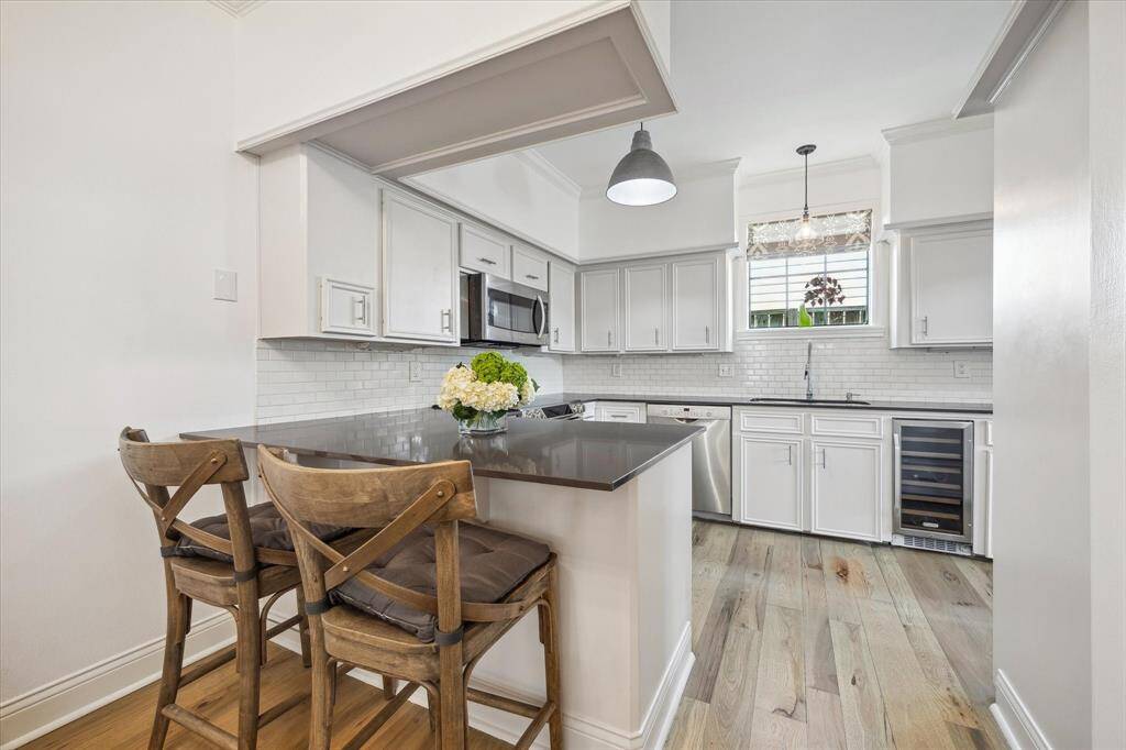 The kitchen also includes a breakfast bar with seating for two and a built-in wine cooler.
