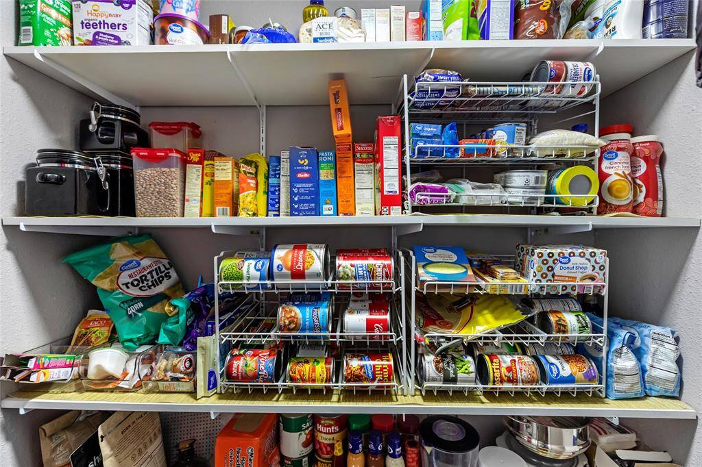 Walk in pantry located in hall across from kitchen.